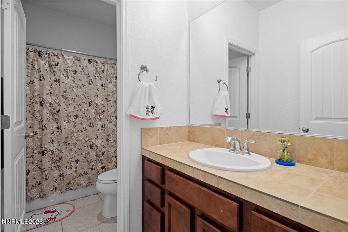 2190 Bears Ranch Drive Reno, NV 89521 - Photo 19 of 23 a bathroom with a sink toilet and shower