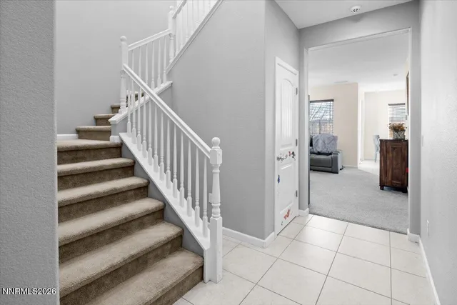a view of a hallway with entryway and kitchen view