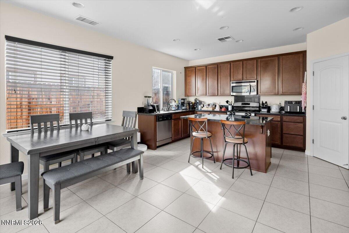 2190 Bears Ranch Drive Reno, NV 89521 - Photo 6 of 23 a kitchen with a table chairs stove and cabinets