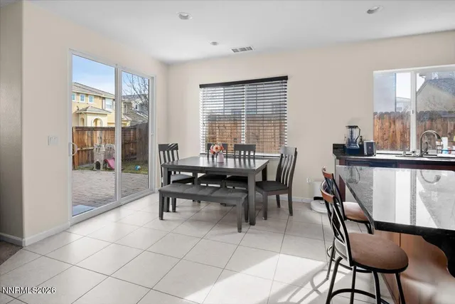 a view of a dining room with furniture and window