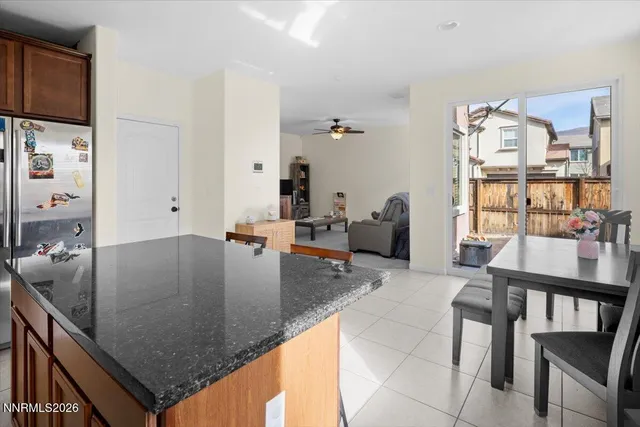 a kitchen with granite countertop a table chairs window and dining table