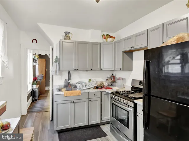 a kitchen with a sink stove and refrigerator