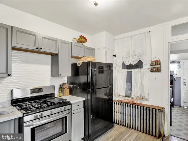 a kitchen with a stove and a refrigerator