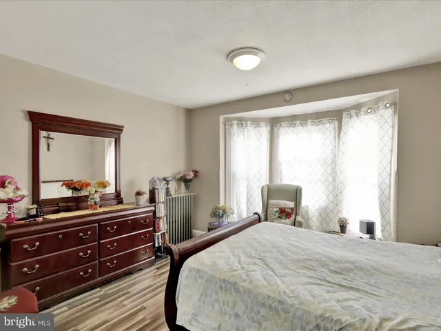 a bedroom with a bed and a dresser