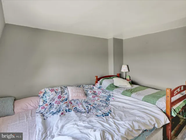 a bedroom with a bed and a lamp