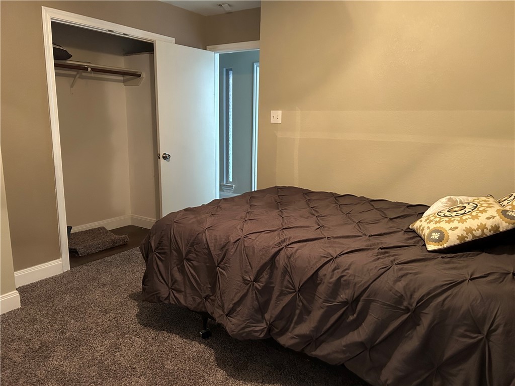 2230 Howell Avenue Bryan, TX 77803 - Photo 12 of 14 a bed sitting in a bedroom next to a bathroom