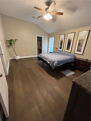 a bedroom with a bed and ceiling fan