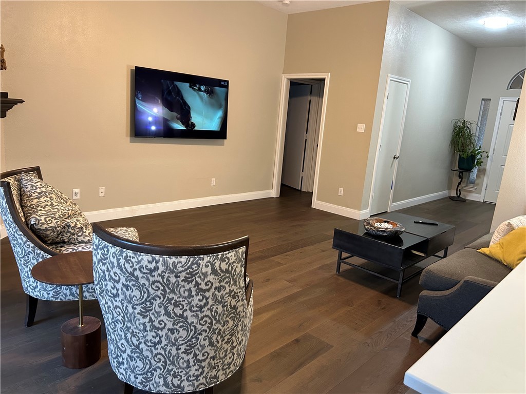 2230 Howell Avenue Bryan, TX 77803 - Photo 7 of 14 a living room with furniture a rug and a flat screen tv