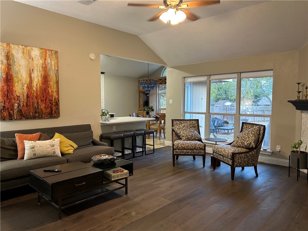 2230 Howell Avenue Bryan, TX 77803 - Photo 8 of 14 a living room with furniture a fireplace and a large window