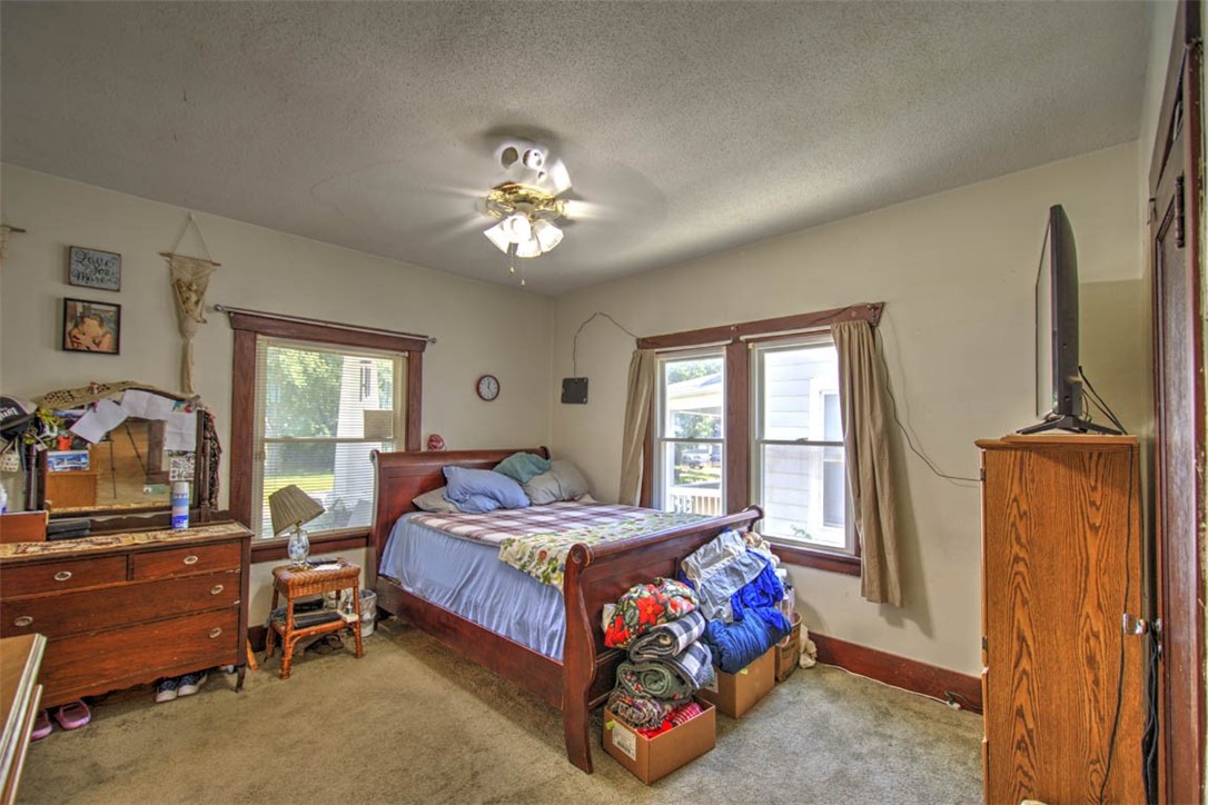 739 West Cushing Street Decatur, IL 62526 - Photo 16 of 28 a bedroom with a bed and a chandelier