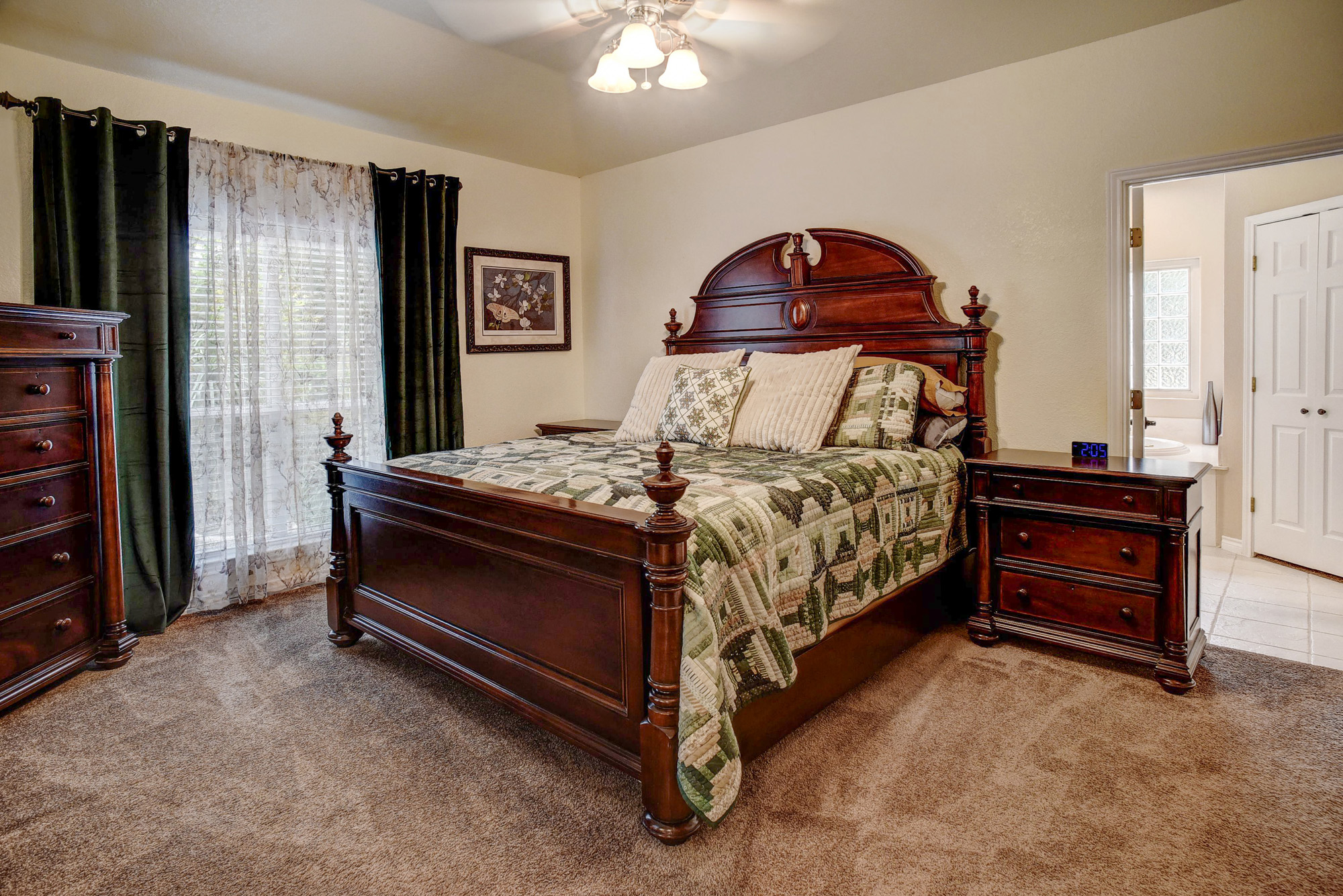 147 Spring Meadow Road Bastrop, TX 78602 - Photo 14 of 40 a bedroom with a bed and a chandelier