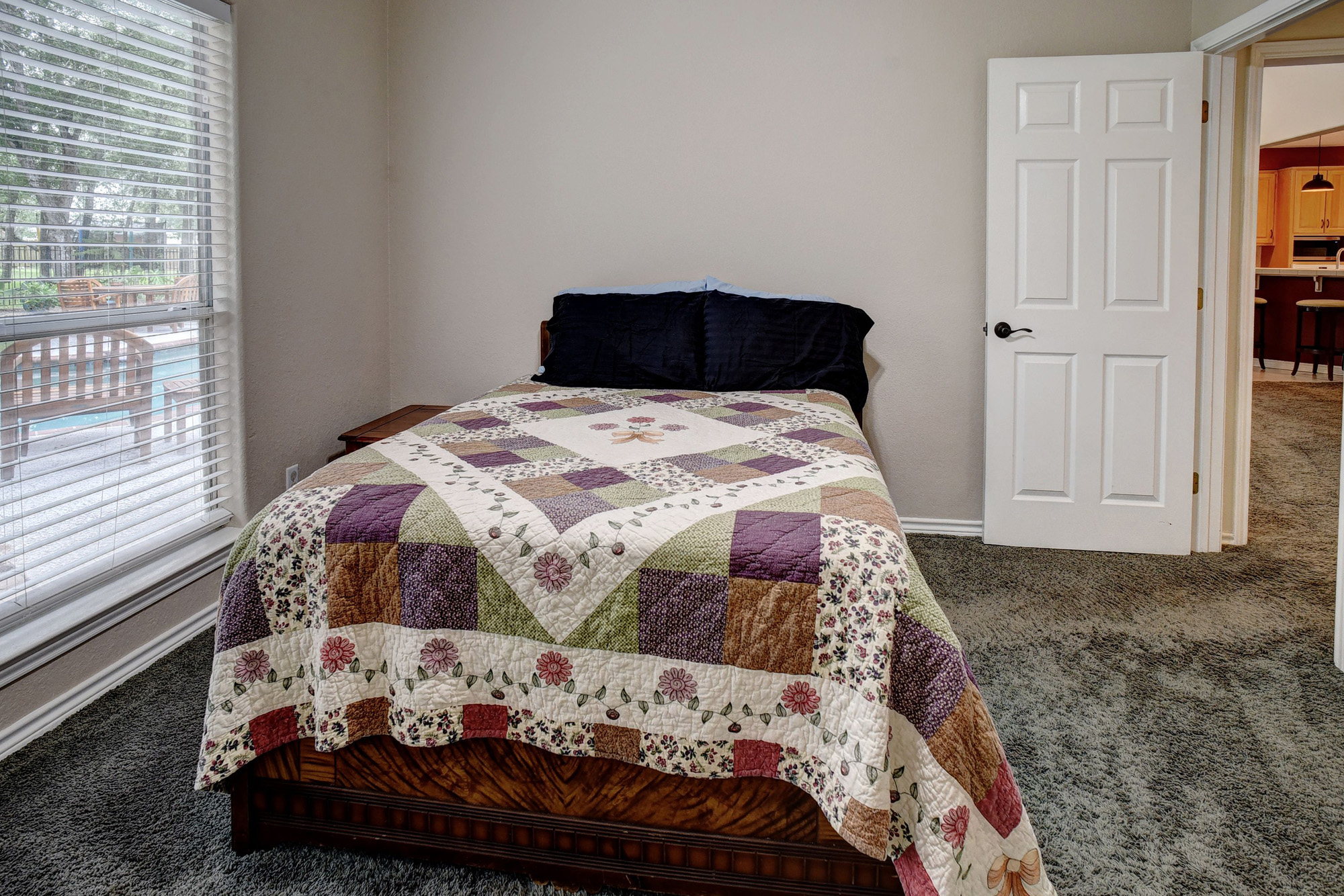 147 Spring Meadow Road Bastrop, TX 78602 - Photo 17 of 40 a bedroom with a bed and a window with rug
