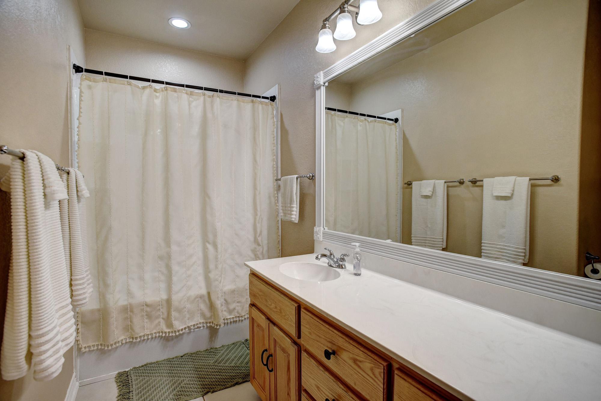 147 Spring Meadow Road Bastrop, TX 78602 - Photo 18 of 40 a bathroom with a double vanity sink and a mirror