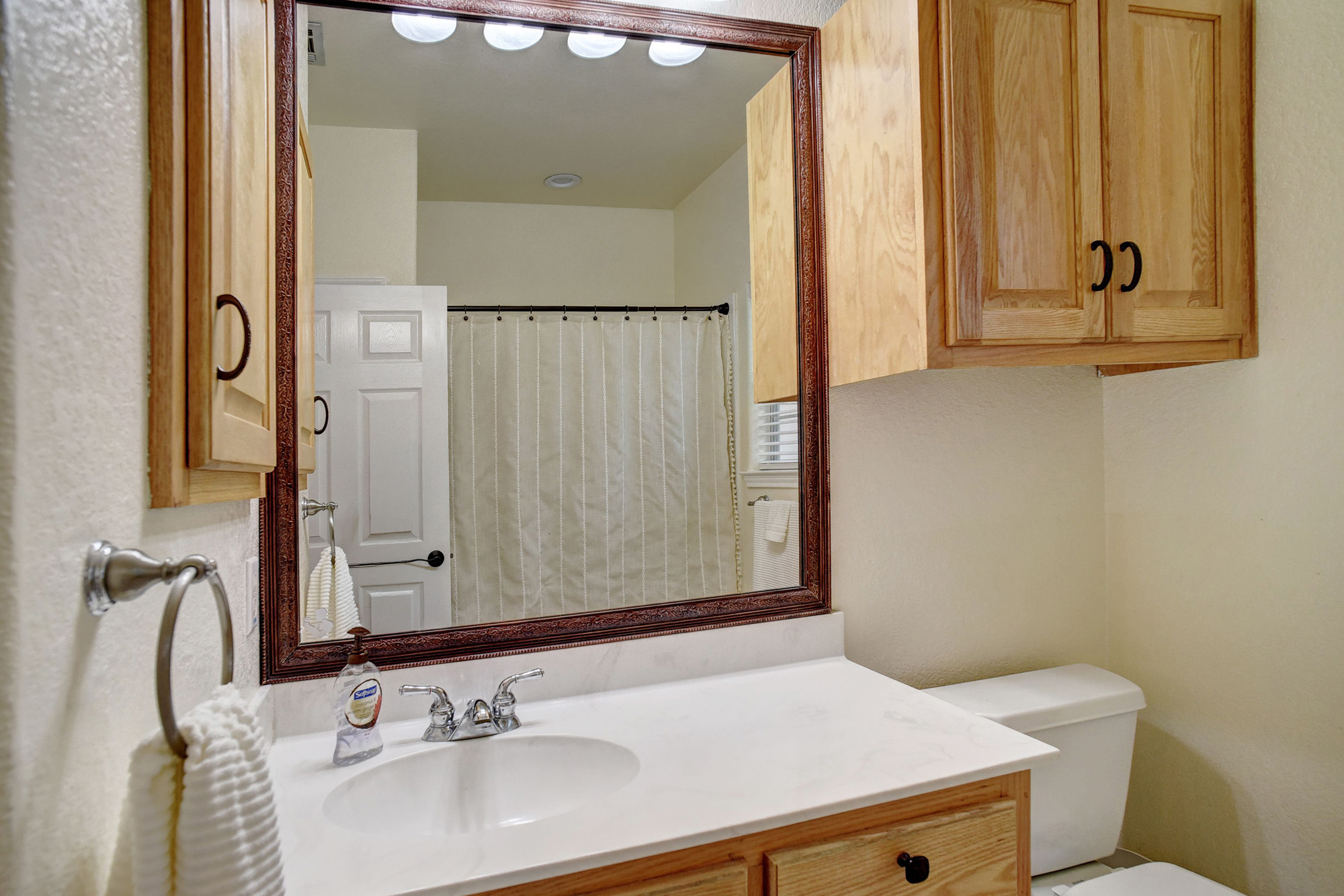 147 Spring Meadow Road Bastrop, TX 78602 - Photo 20 of 40 a bathroom with a sink and a mirror