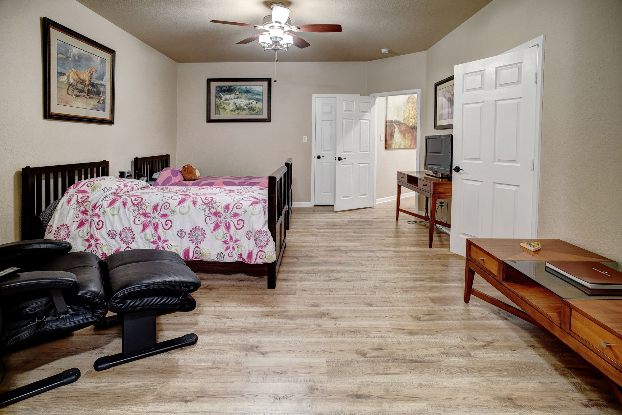 147 Spring Meadow Road Bastrop, TX 78602 - Photo 26 of 40 a bedroom with furniture and wooden floor