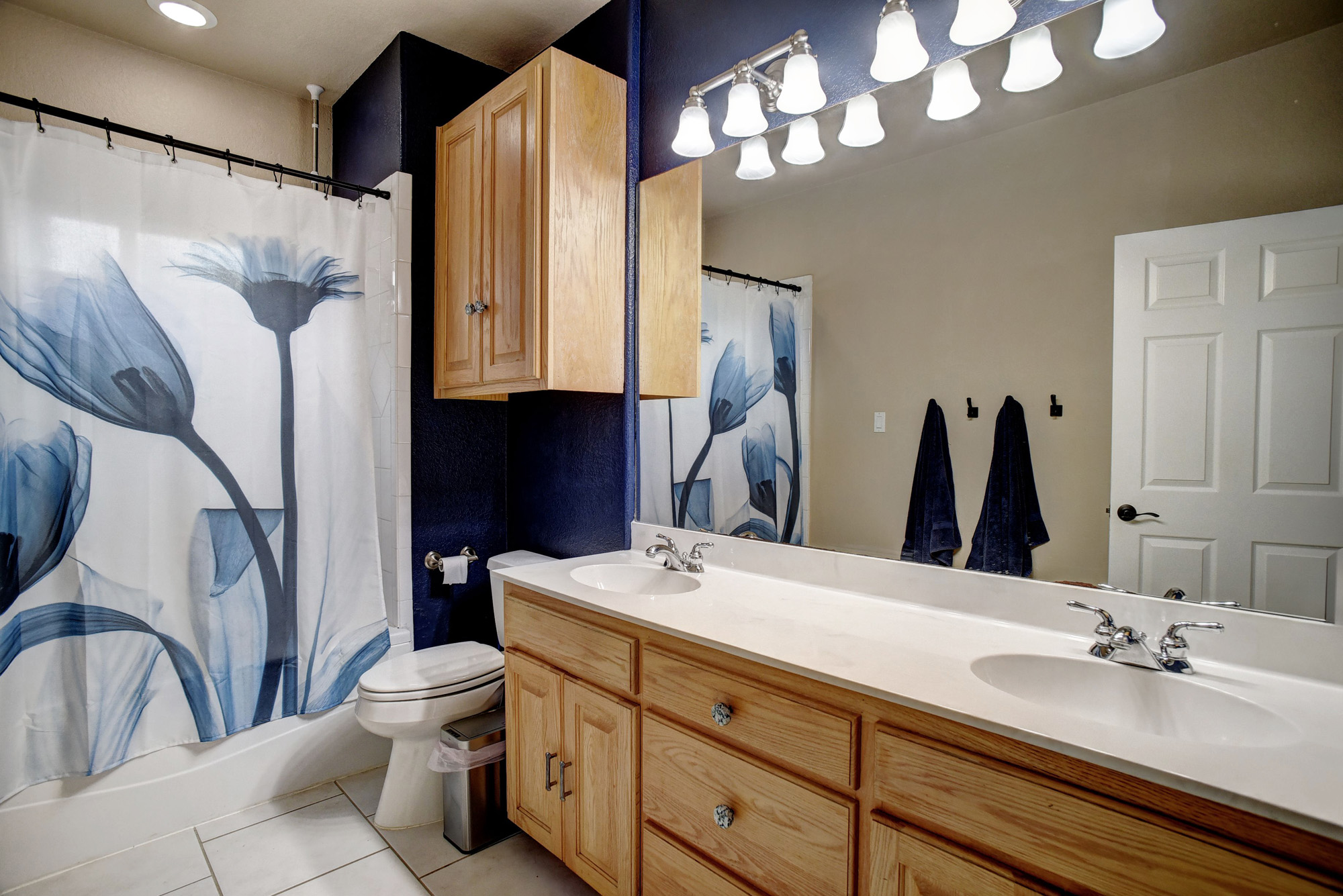 147 Spring Meadow Road Bastrop, TX 78602 - Photo 27 of 40 a bathroom with a double vanity sink and a mirror