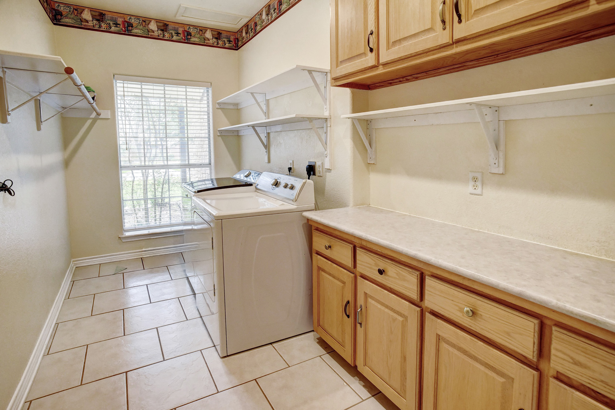 147 Spring Meadow Road Bastrop, TX 78602 - Photo 28 of 40 a utility room with cabinets washer and dryer