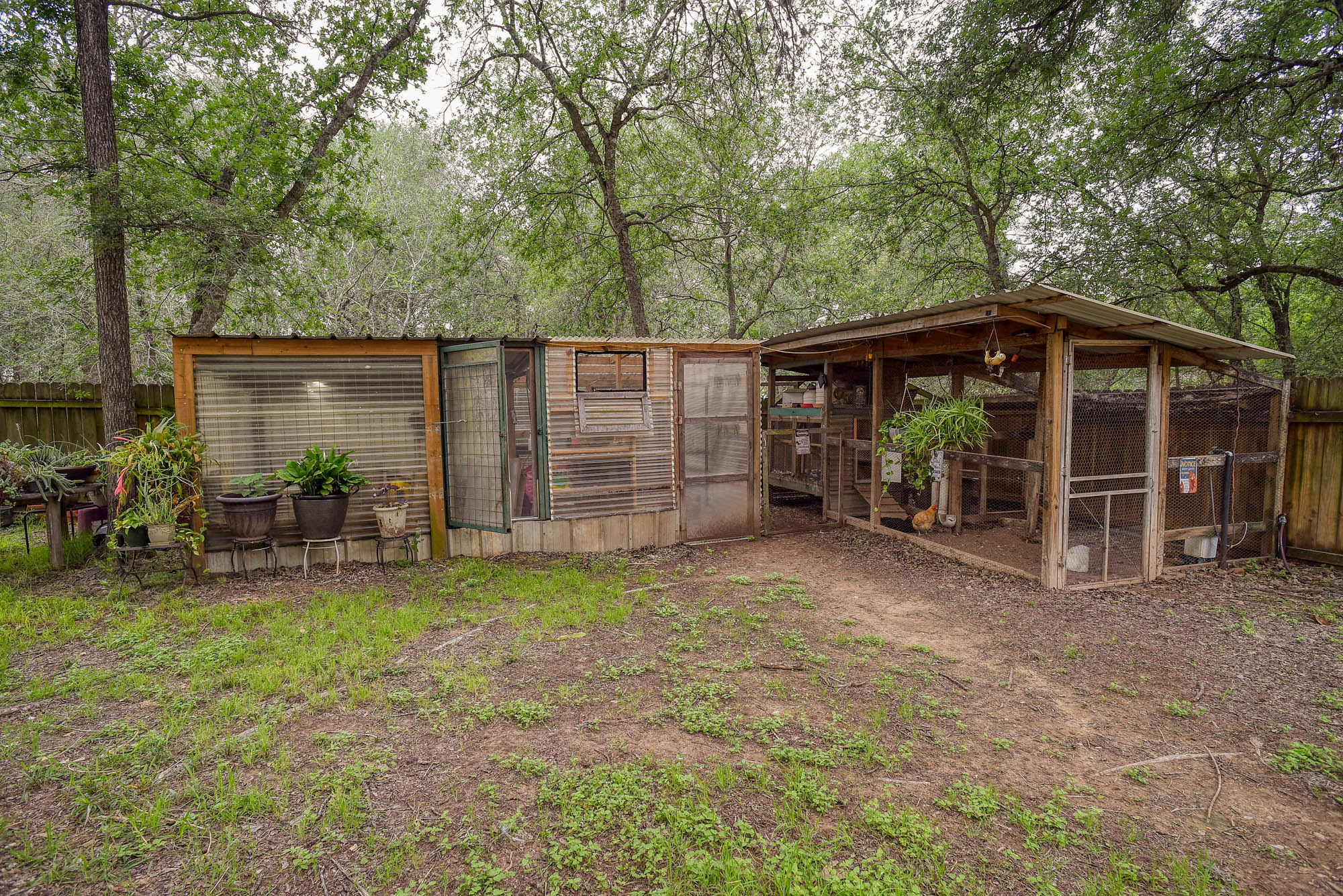 147 Spring Meadow Road Bastrop, TX 78602 - Photo 35 of 40 a view of a backyard with a small cabin and a chair