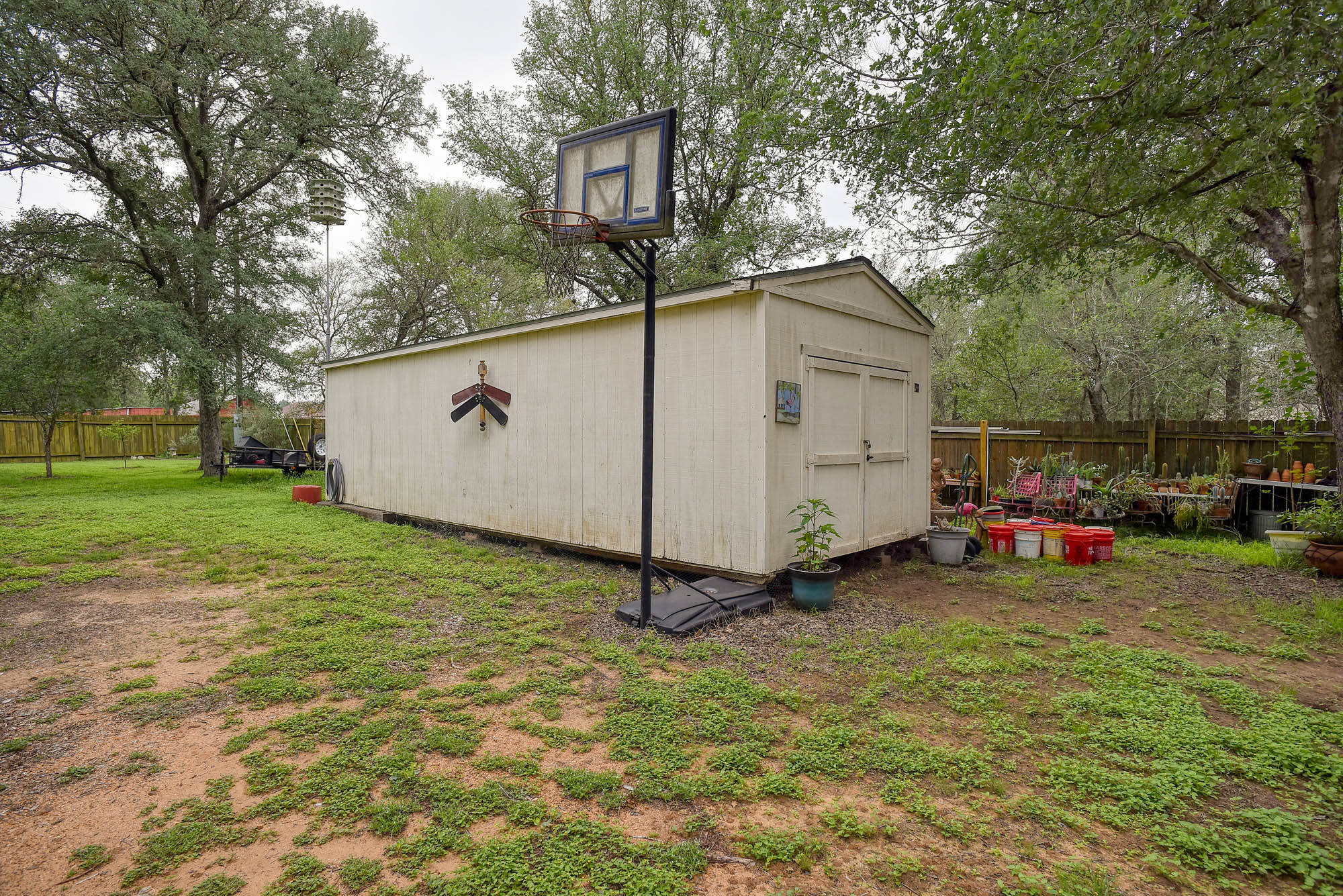 147 Spring Meadow Road Bastrop, TX 78602 - Photo 36 of 40 a view of a backyard with a car