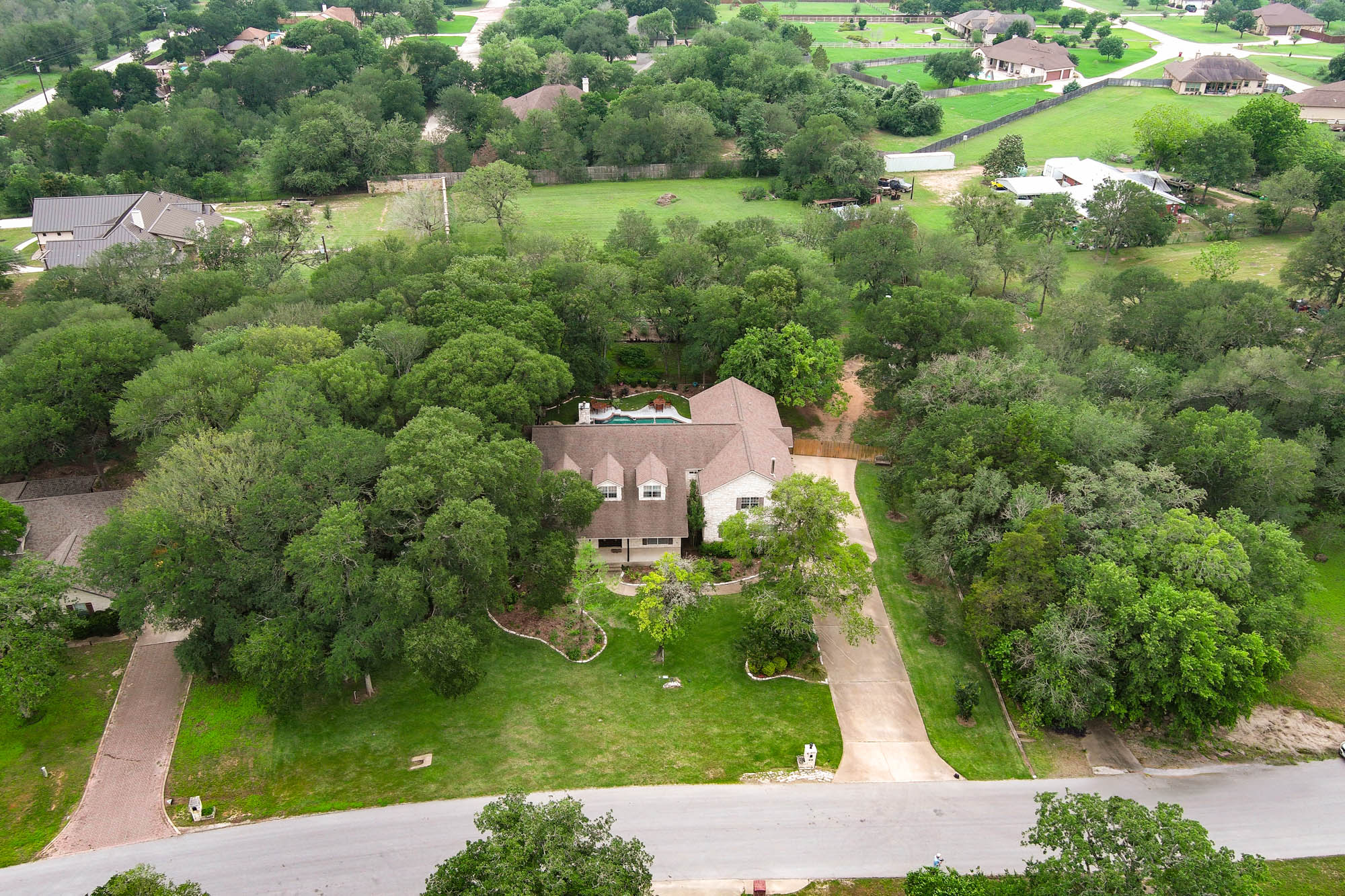 147 Spring Meadow Road Bastrop, TX 78602 - Photo 37 of 40 a view of a garden with a building