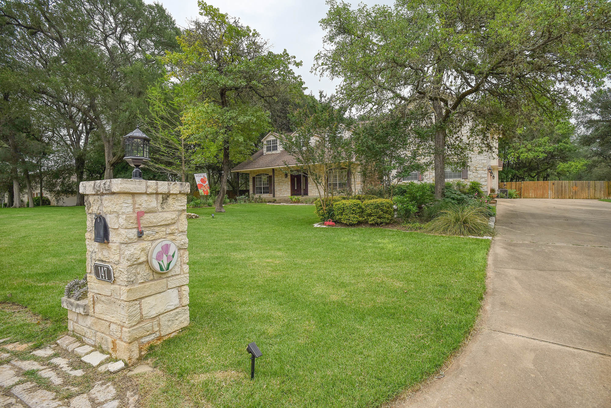 147 Spring Meadow Road Bastrop, TX 78602 - Photo 4 of 40 a front view of a house with garden