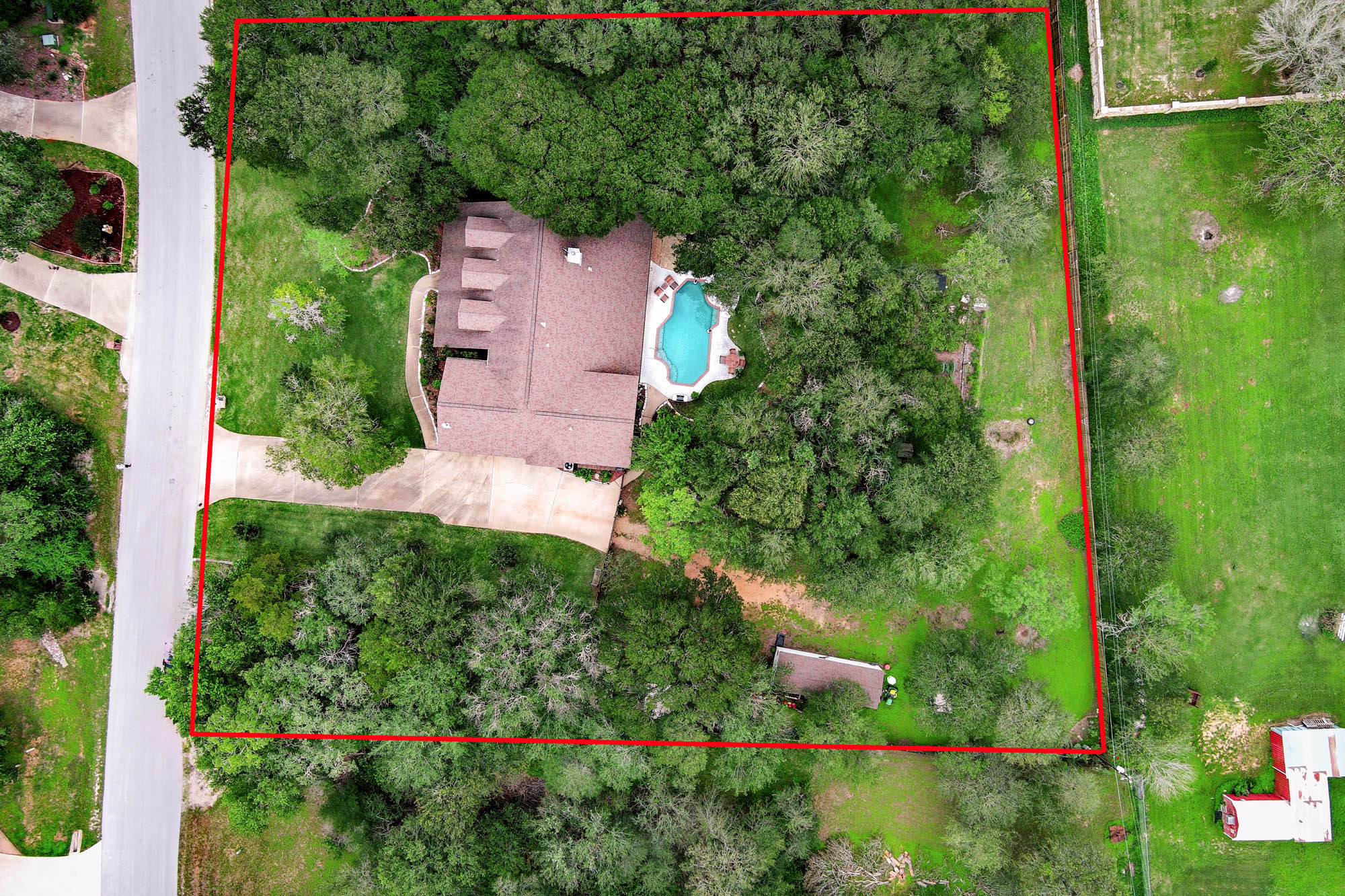 147 Spring Meadow Road Bastrop, TX 78602 - Photo 5 of 40 an aerial view of a house with a yard and lake view
