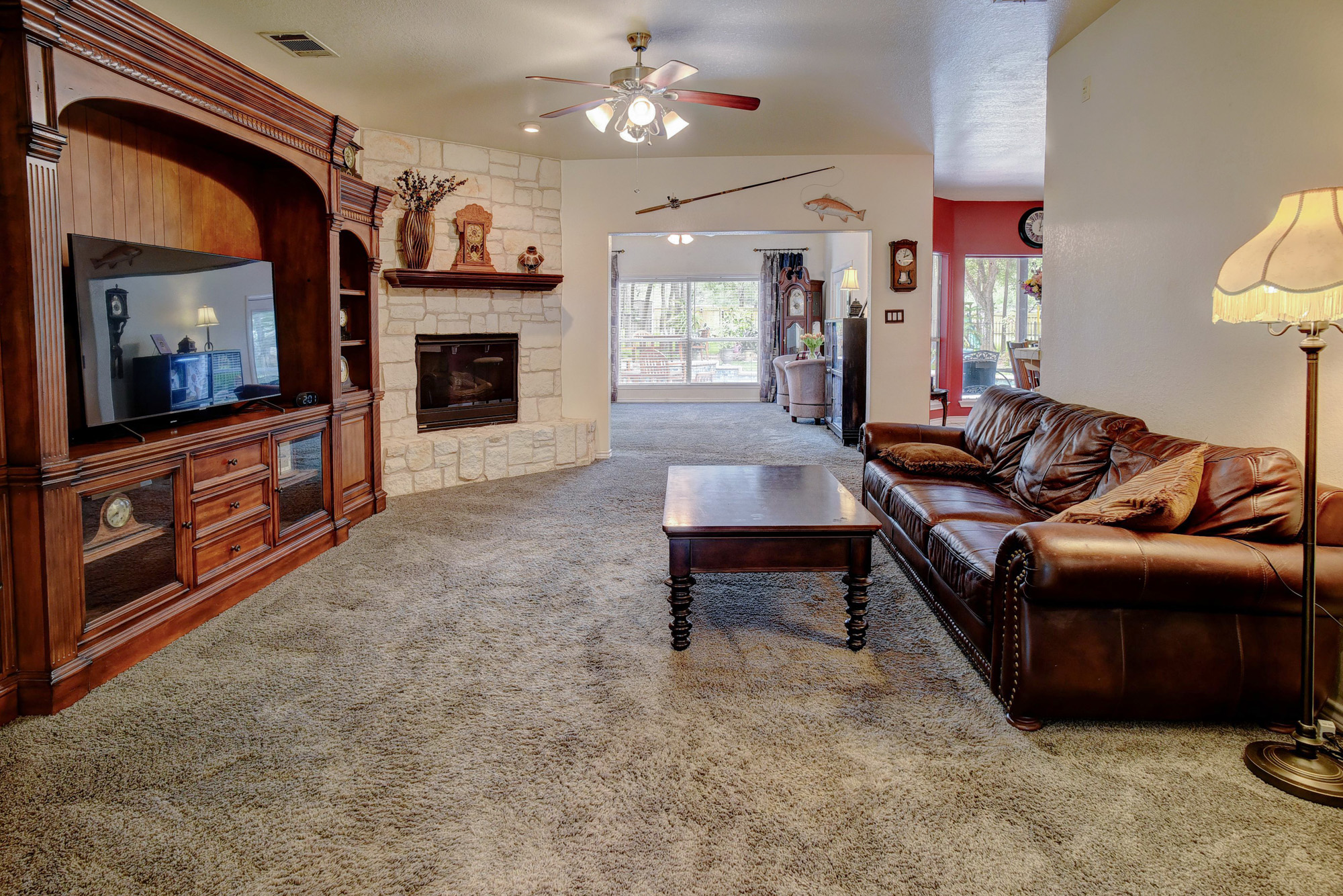 147 Spring Meadow Road Bastrop, TX 78602 - Photo 7 of 40 a living room with furniture a flat screen tv and a fireplace