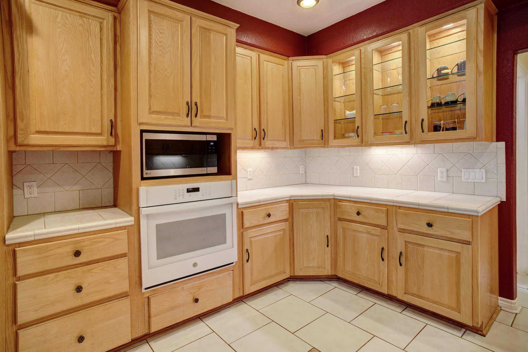 147 Spring Meadow Road Bastrop, TX 78602 - Photo 9 of 40 a kitchen with stainless steel appliances white cabinets and a stove top oven