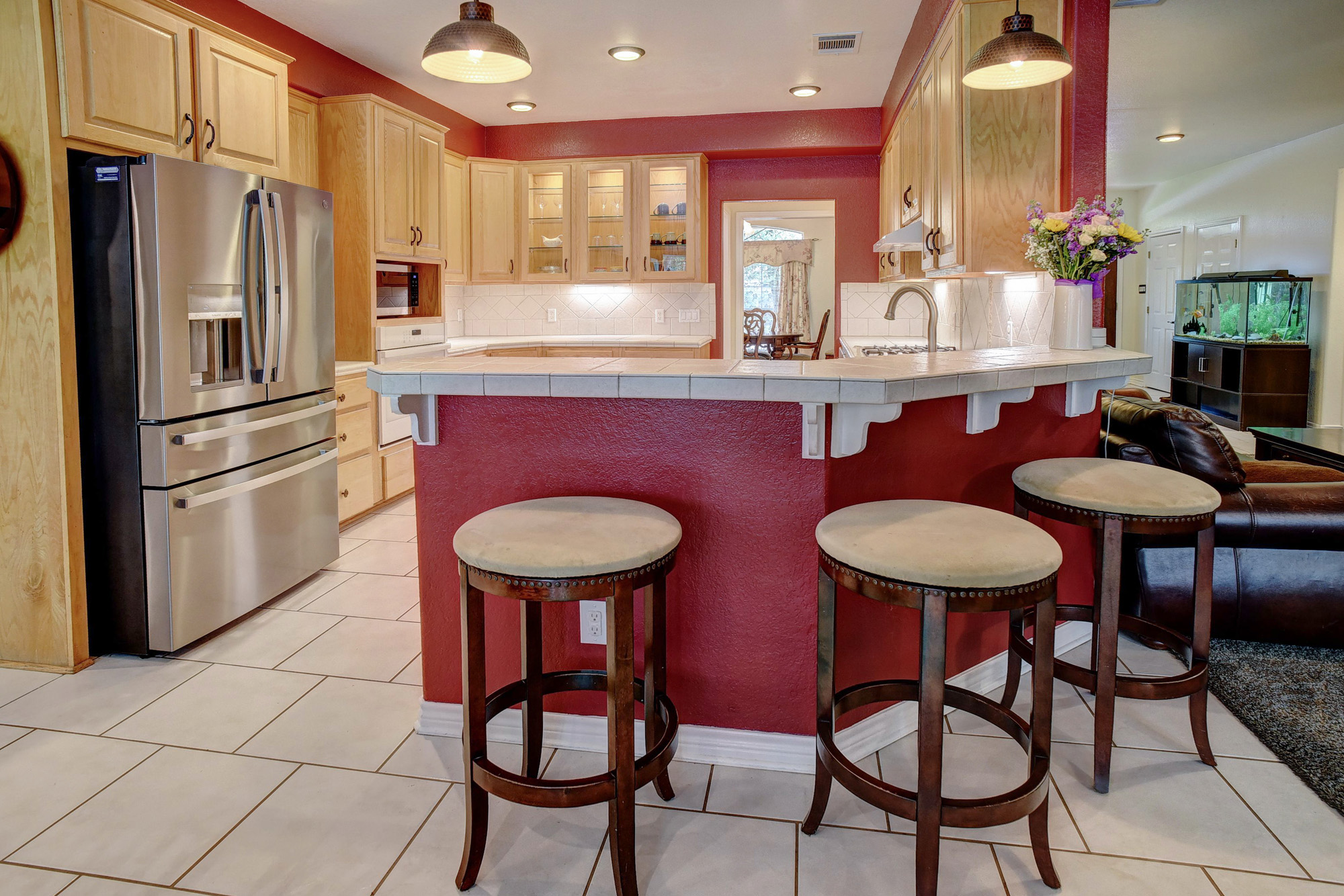 147 Spring Meadow Road Bastrop, TX 78602 - Photo 10 of 40 a kitchen with stainless steel appliances granite countertop a sink a stove a refrigerator with a dining table and chairs