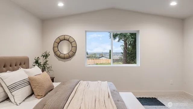 a bedroom with a large bed and a window