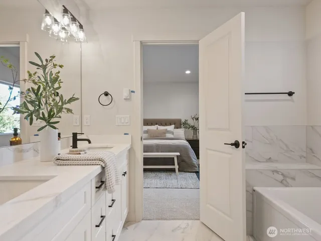 a en suite bathroom with a double vanity sink a large mirror and shower