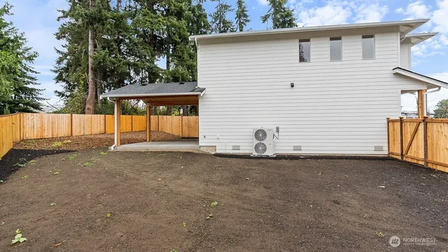 a view of a backyard with a tree