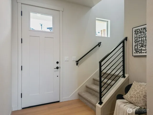 a view of entryway and hall with wooden floor