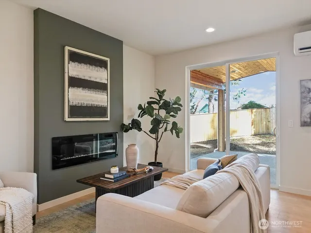a living room with furniture fireplace and a window