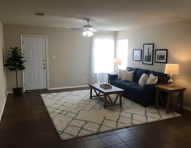 a living room with furniture and a potted plant