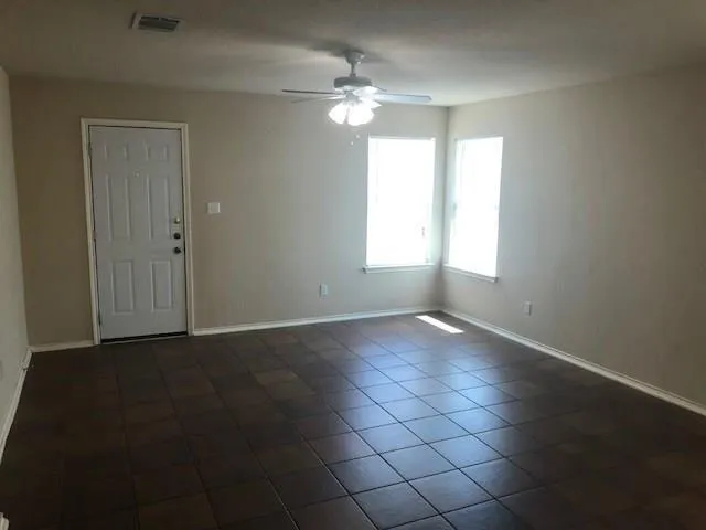 a view of an empty room with a window