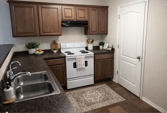 a kitchen with a sink stove and cabinets