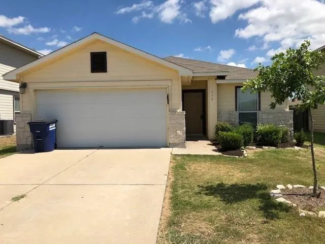 a view of a white house with a yard
