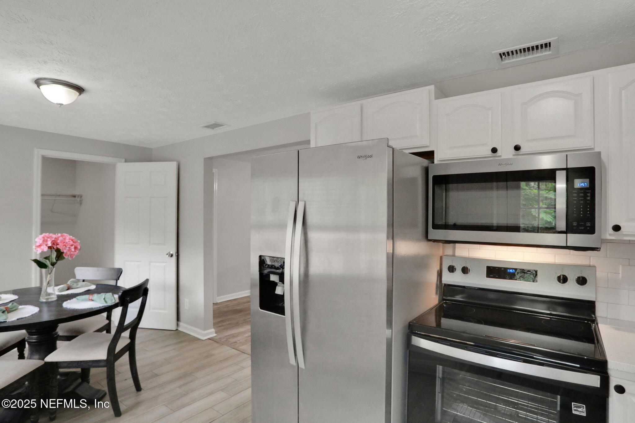 3822 Packard Drive Jacksonville, FL 32246 - Photo 11 of 38 a kitchen with a refrigerator and a stove top oven