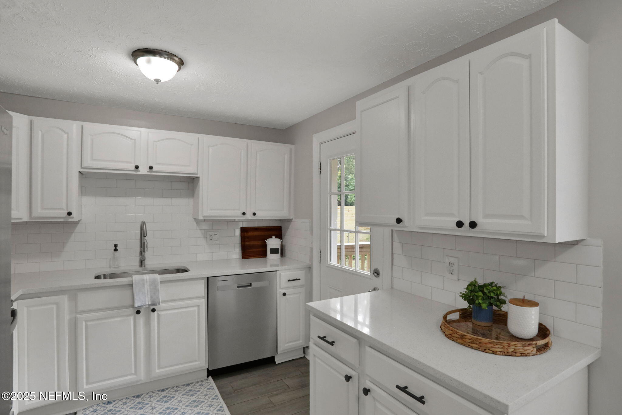 3822 Packard Drive Jacksonville, FL 32246 - Photo 13 of 38 a kitchen with white cabinets and sink
