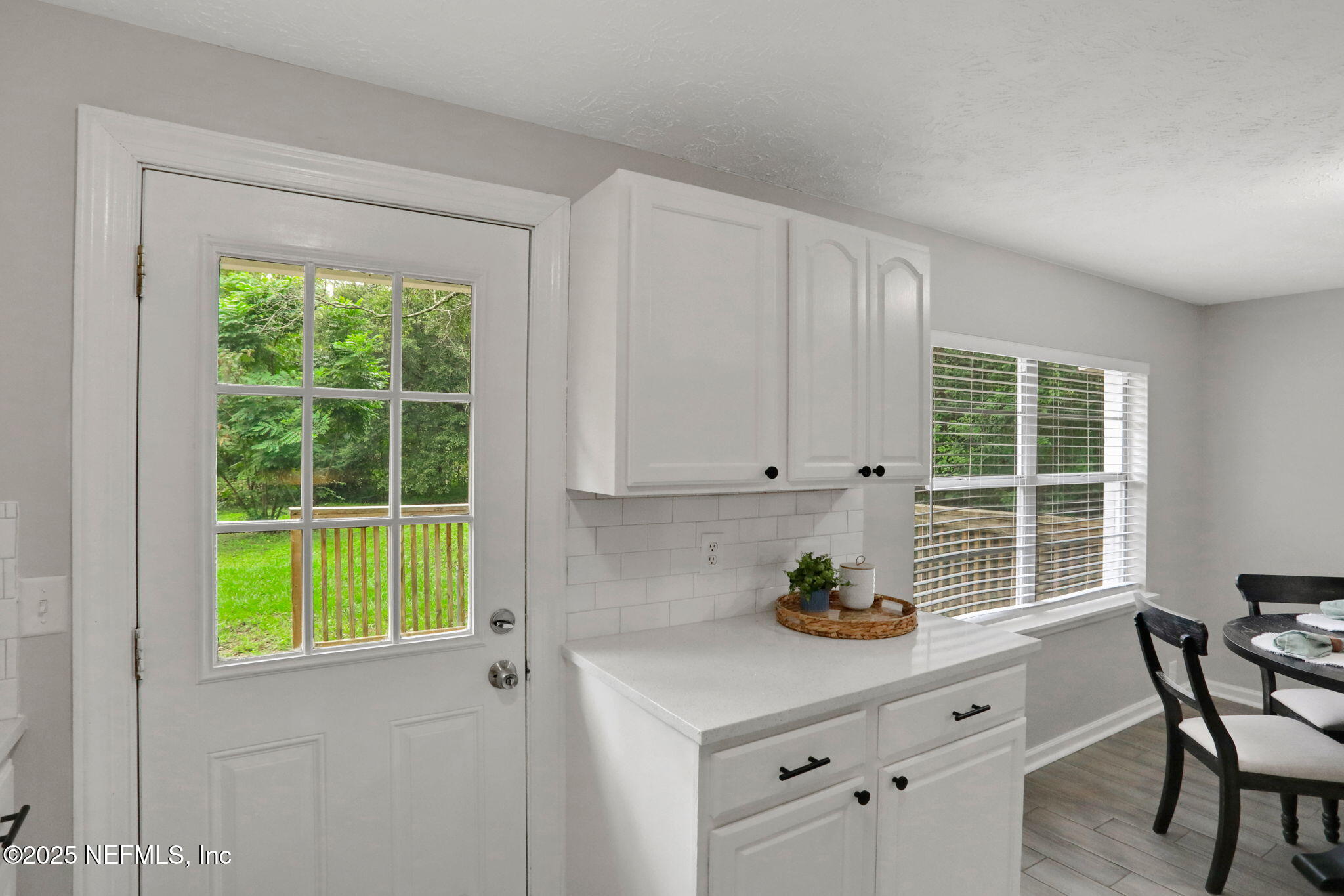 3822 Packard Drive Jacksonville, FL 32246 - Photo 15 of 38 a kitchen with stainless steel appliances white cabinets and a window