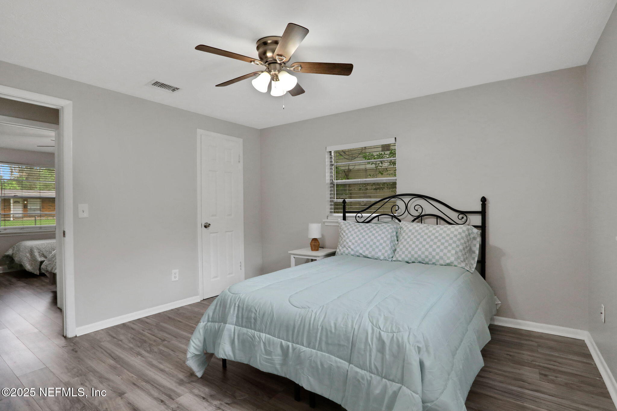 3822 Packard Drive Jacksonville, FL 32246 - Photo 25 of 38 a bedroom with a bed and a chandelier