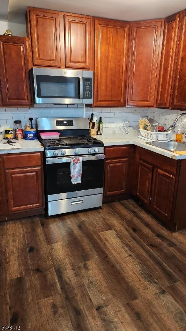 522 Chestnut Street, Unit 2 Orange, NJ 07050 - Photo 5 of 8 a kitchen with stainless steel appliances granite countertop a stove microwave and sink