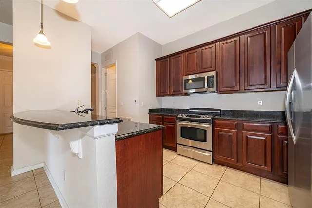 a large kitchen with cabinets and stainless steel appliances
