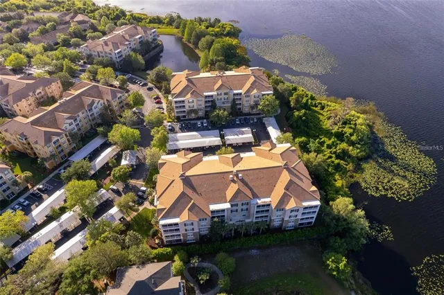 an aerial view of a house with a swimming pool outdoor seating and yard