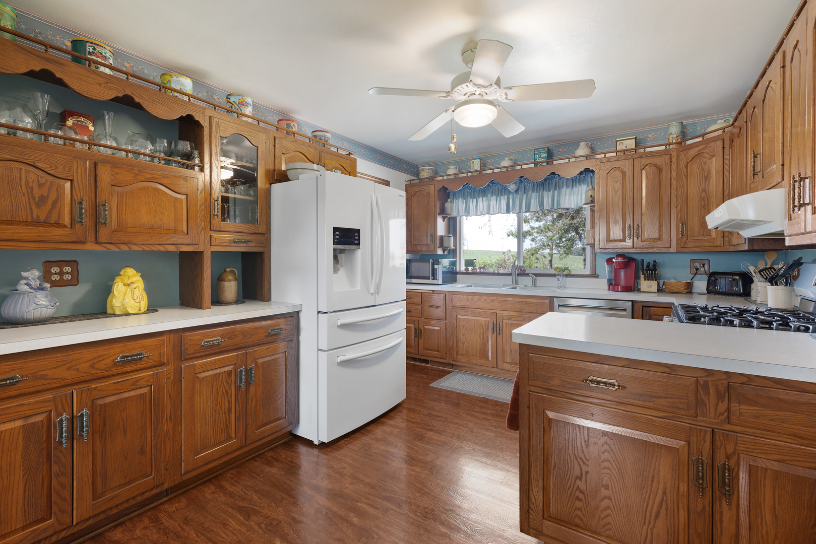 50W424 Plank Road Sycamore, IL 60178 - Photo 2 of 22 a kitchen with granite countertop a white refrigerator oven a sink a dining table and chairs with wooden floor