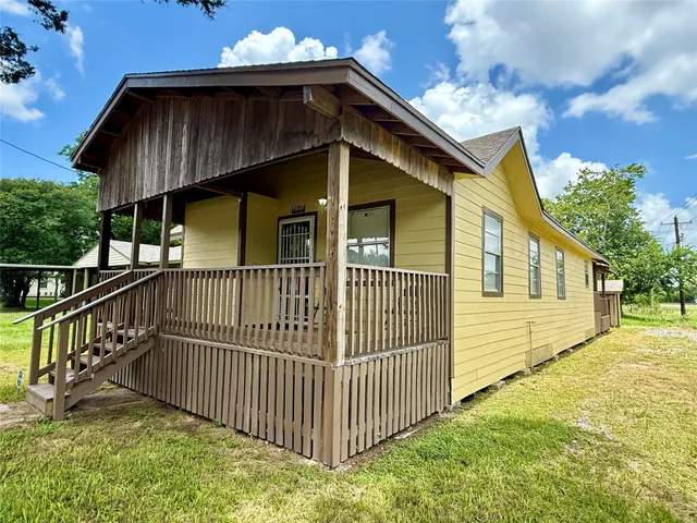 a view of a house with wooden fence