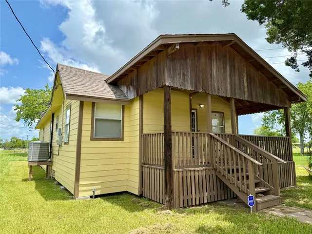 a view of a house with wooden fence