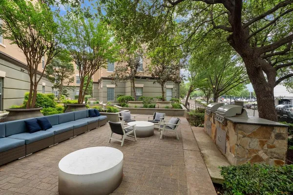 a view of a patio with couches table and chairs with wooden fence and floor