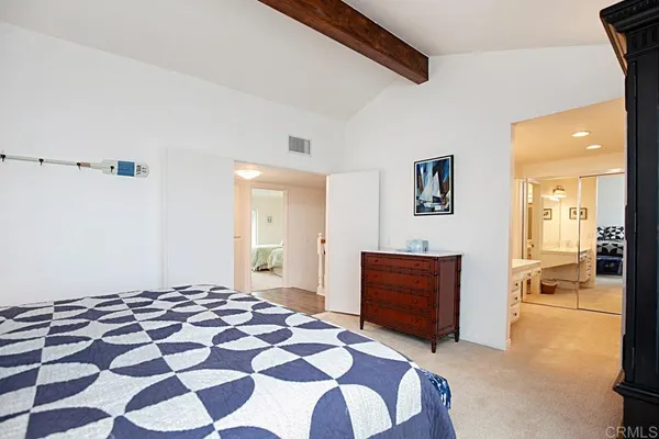 a bedroom with a bed and a dresser